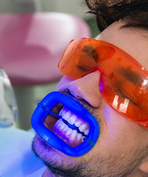 man wearing protective gear teeth whitening