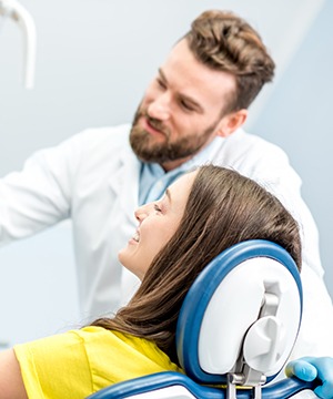 Dentist and patient reviewing X-ray together